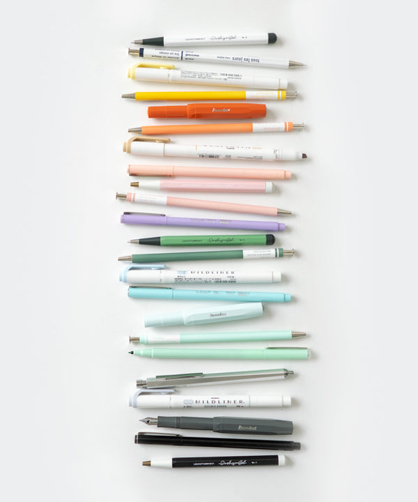 a rainbow of assorted writing tools including pens, pencils, and highlighters, sits against a white background